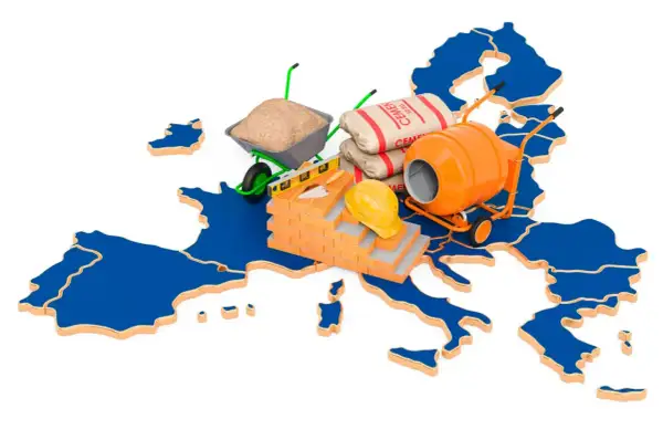 Mapa Europy z materiałami budowlanymi: cement, betoniarka, taczka, cegły, kask.